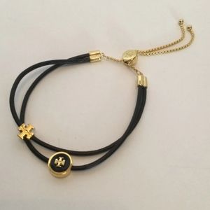 Tory Burch "Kira" black enamel slide bracelet.